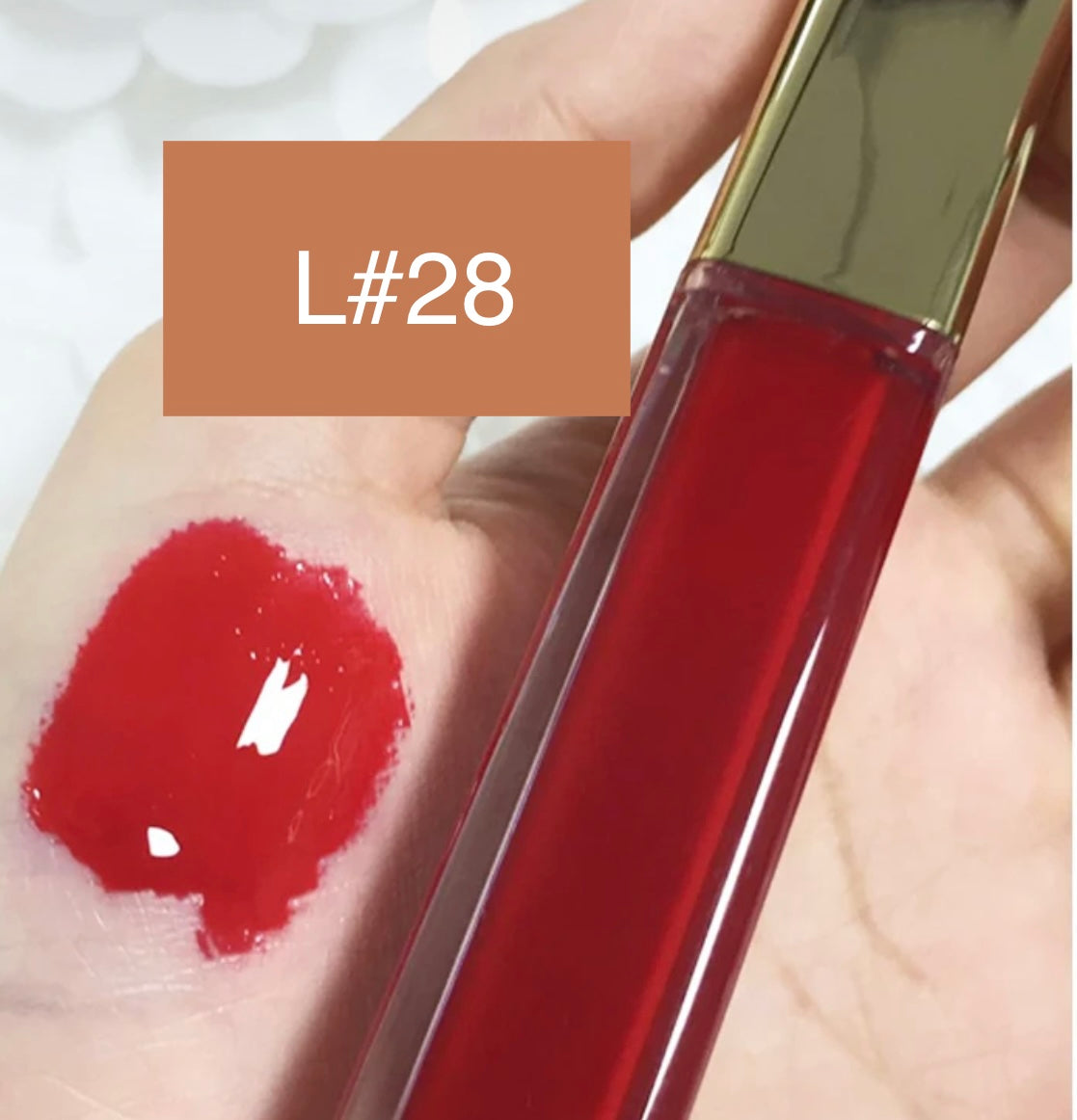 High-Shine Vegan Lip Gloss in variant of L28, providing a vibrant L28 with a glossy shine
