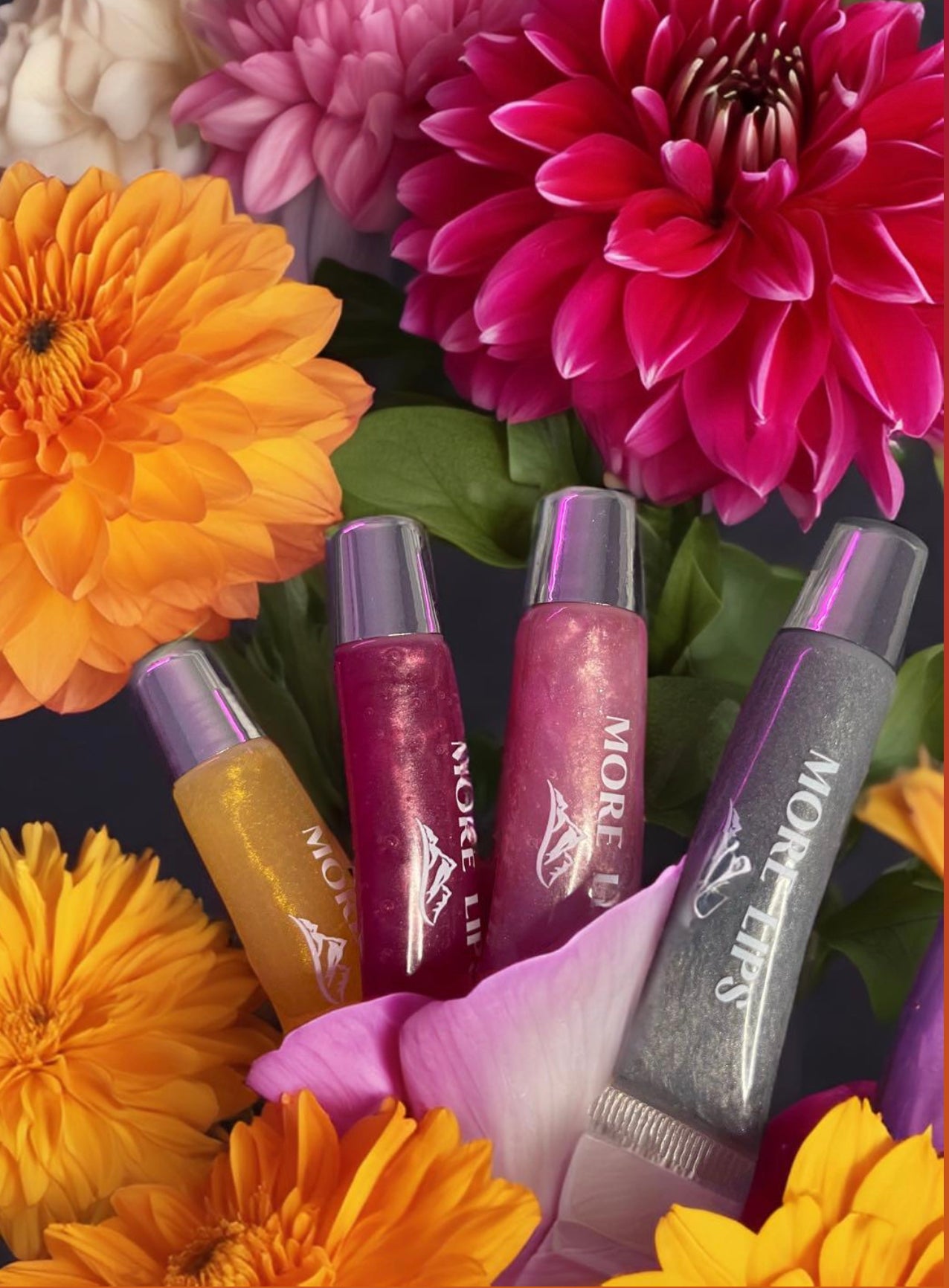 Image of More Lips Vegan Lip Gloss in various shades, showcasing vibrant colors and luscious shine